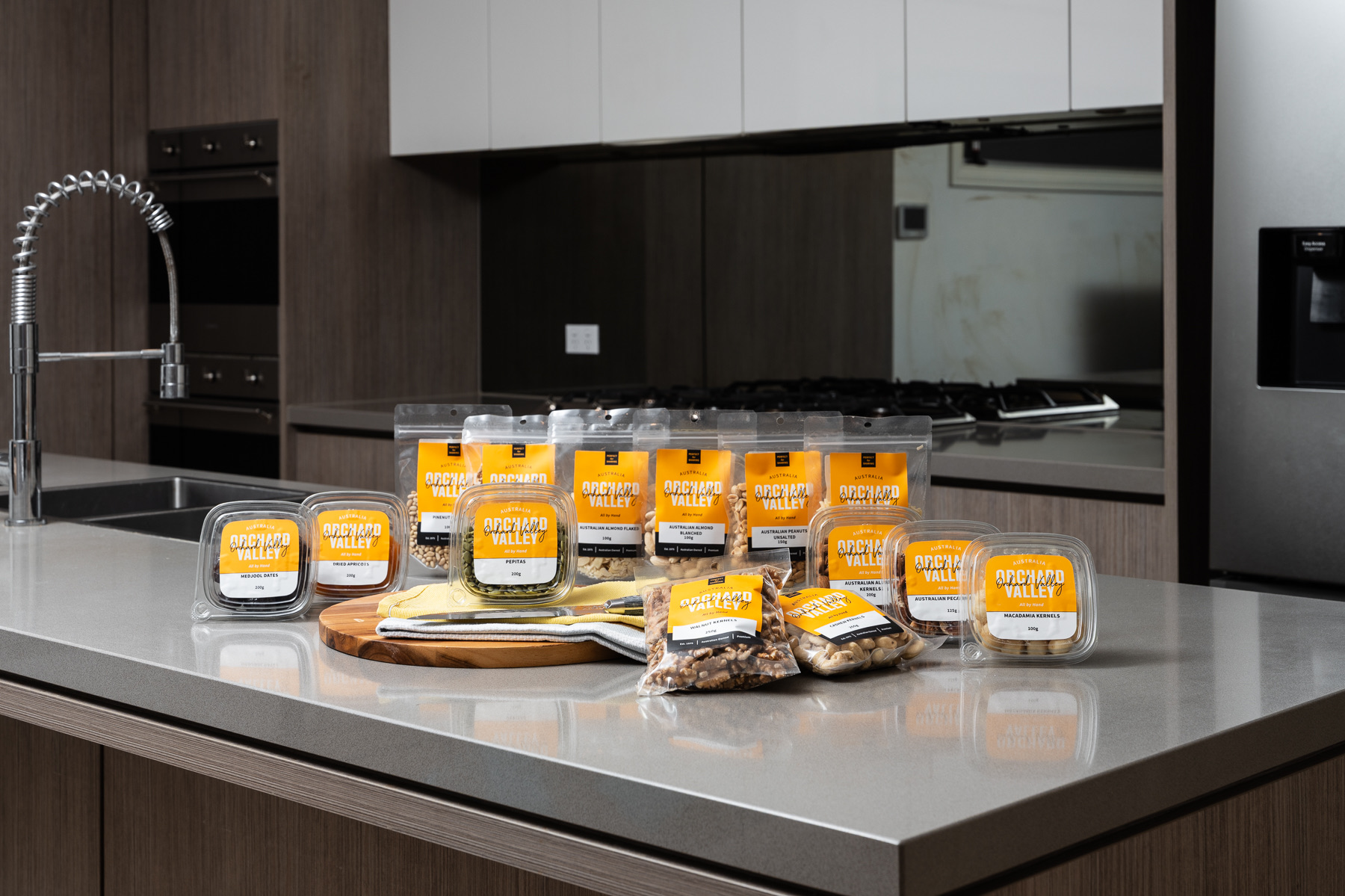 The Orchard Valley range on a kitchen bench, walnuts front and centre