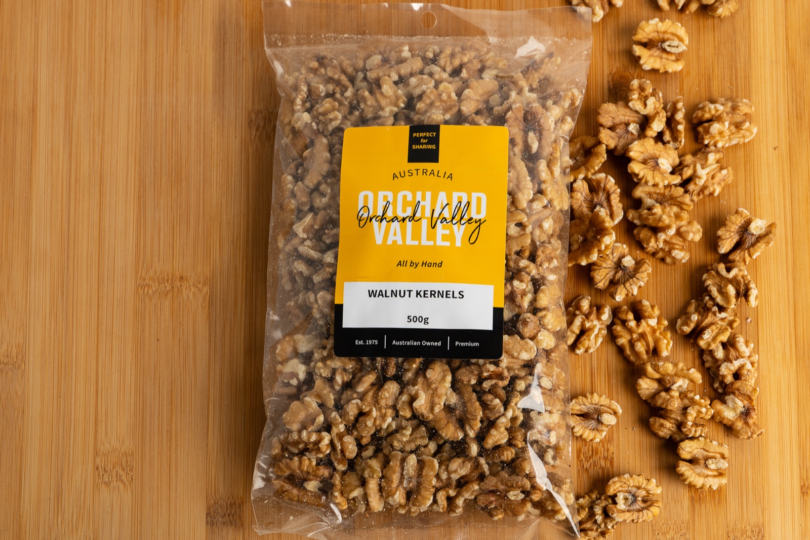 Orchard Valley walnut kernels 500g on a timber board